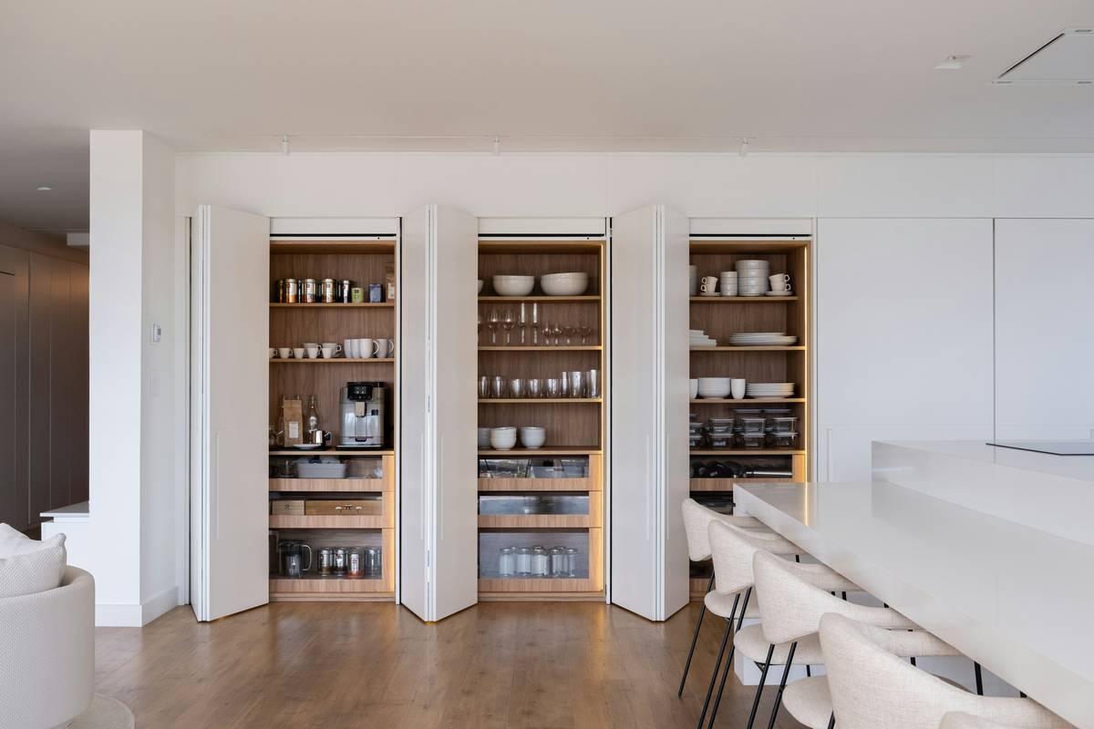 storage unit furniture tall in a modern living room holding books, baskets, and decorative items