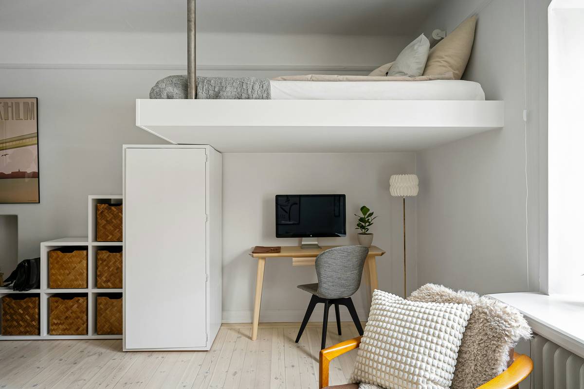Modern space saving storage cabinet mounted in narrow hallway with baskets and labeled bins