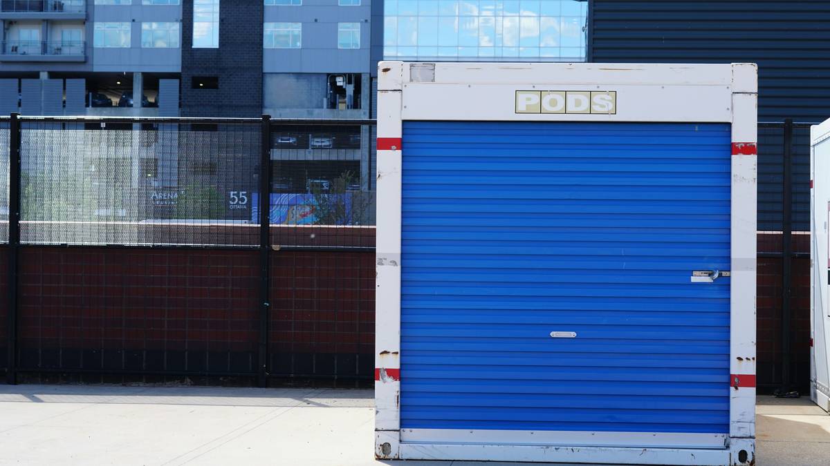 small exterior storage unit filled with garden tools and outdoor gear on a patio