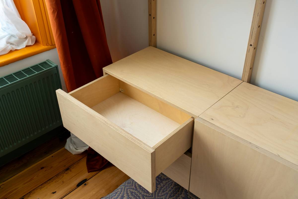 storage cabinet bobs furniture showing reinforced dovetail joints, full-extension soft-close glides, and solid wood drawer fronts