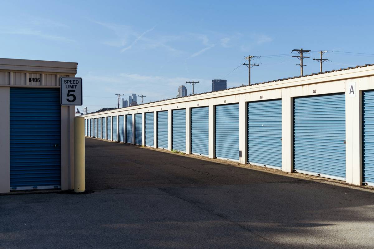 storage units brought to your home being carefully unloaded by two movers near a suburban front door
